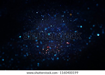glitter vintage lights background. black and blue. de-focused