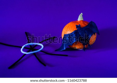 Symbol of HALLOWEEN is Orange pumpkin, bat  and black spiderweb on purple background,copy space, closeup,