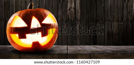 Halloween pumpkin on dark wooden background
