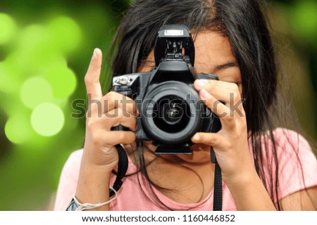 A little girl taking photo 