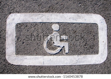 Desabled on wheelchair parking sign on the asphalt