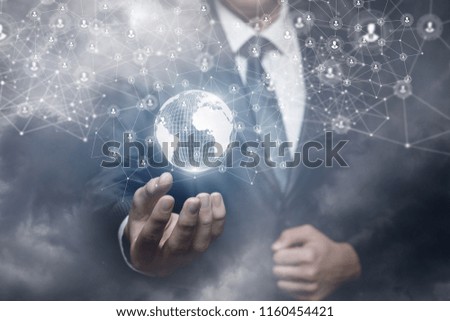 Man shows a global network in the hand on sky background.