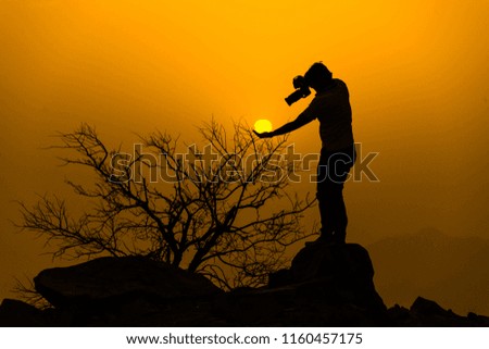 Silhouetted photographer while posing fore creative photography,  Taif,  Saudi arabia 