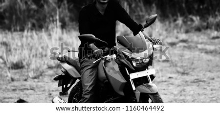 Young man riding a bike wearing black shirt isolated unique photo