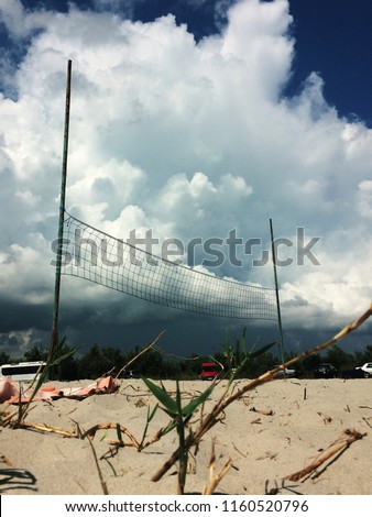 volleyball on the beach with clouds on background, cumulus clouds before thunderstorm