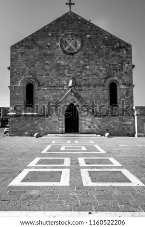 This is a black and white photograph of a church in roads. It had very interesting leading Lines the church