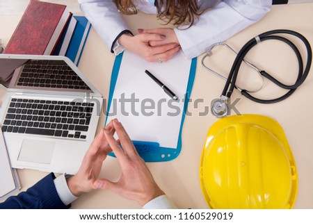 Doctor and manager agreeing industrial insurance coverage Royalty-Free Stock Photo #1160529019