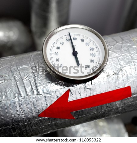 industrial thermometer red arrow on a water pipeline
