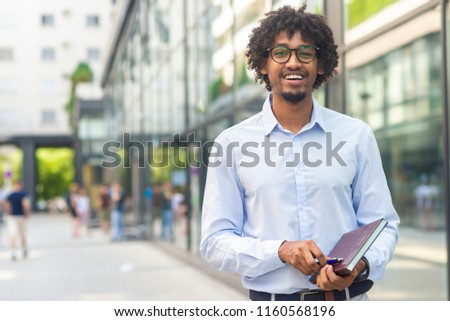 Portrait of business man holding note book