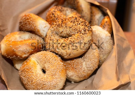Variety of assorted authentic New York style Bagels with seeds in a brown paper bag. Royalty-Free Stock Photo #1160600023