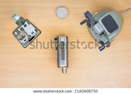 Flat lay photography of old film editing method. Vintage equipment: Film strip slicer, Cine Film Viewer Editor and Regular and Super Film camera. Concept of editing. Top view.