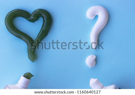 Heart symbol and question mark from toothpaste. Concept of dental care