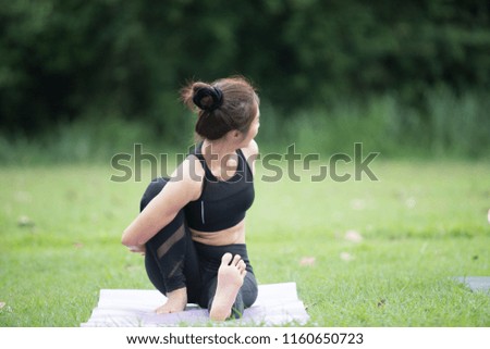 Young sport girl do yoga in the park, asian beauty woman