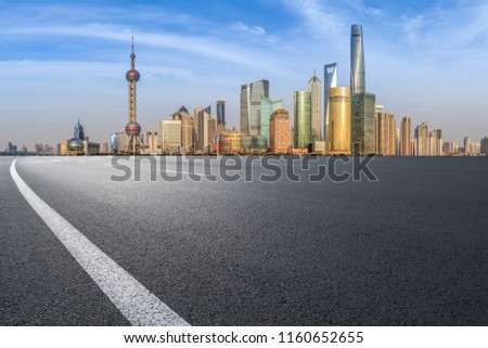 Foreground highway asphalt pavement city building commercial bui