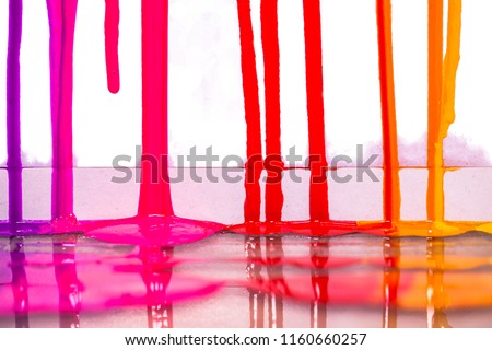 purple pink and red colors of screen print colors are dripping in white background