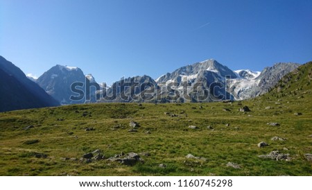 Picturesque view on Mont Collon and Pigne d'Arolla summits in a beautiful morning light from a trekking path on a sunny Summer morning - Switzerland