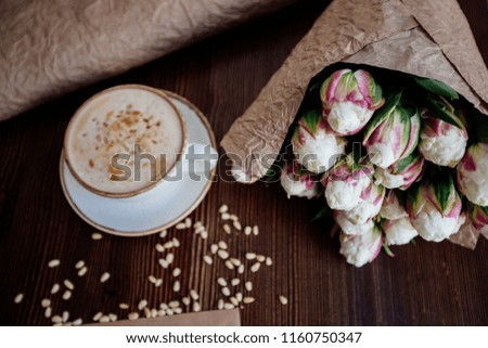 Cappuccino with nuts on the table.