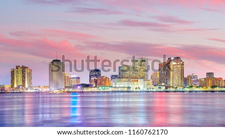 Downtown New Orleans, Louisiana and the Mississippi River at twilight in USA