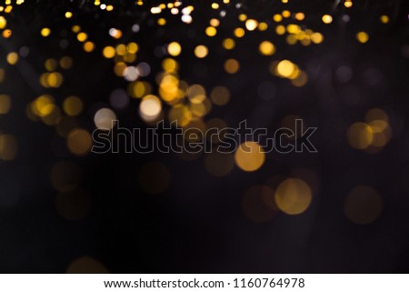 Yellow bokeh and black background can be used for designing images.