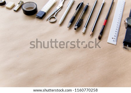 stationery pen scissors notebook on a wooden table