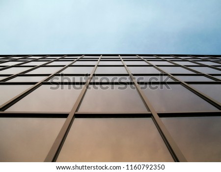 glass wall of modern trade center over the blue sky