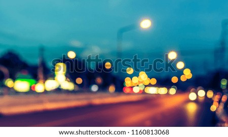 Abstract blur image of Road in evening time  with light bokeh for background usage . (vintage tone)