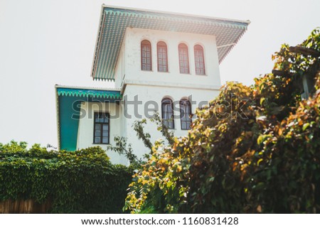 White house with blue roof in traditional oriental style