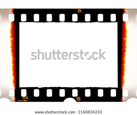 Old fashioned 35mm filmstrip or dia slide frame with burned edges isolated on white background. Real analog film scan with signs of usage. Royalty-Free Stock Photo #1160834233