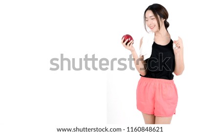 Beautiful young asian girl in sportwear with white towel holding red apple on white background. Studio shot, being fit and healthy sport concept. Healthy lifestyle.