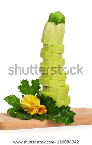 Fresh green vegetable marrow with leaf on chopping board