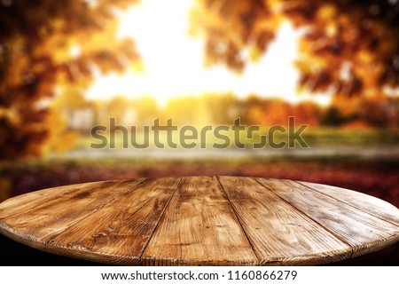 Table background and autumn landscape. Free space for your decoration. 