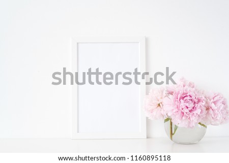 Minimal feminine white blank a4 frame mockup. Floral bouquet of pink peonies in transparent vase. Background, mock up for quote, promotion, headline, design, lifestyle bloggers and social media