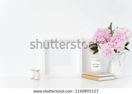 White square blank frame mockup. Still life composition, floral elegant bouquet of pink peonies in jug, silk ribbons. Background, mock up for quote, promotion, headline and social media