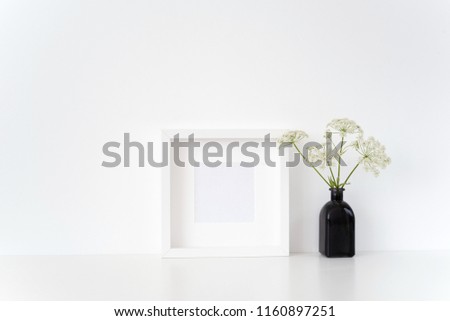 Elegant white square frame mock up with a herbal Gerard in black vase on white background. Mockup for quote, promotion, headline, design. poster for small businesses, lifestyle bloggers, social media