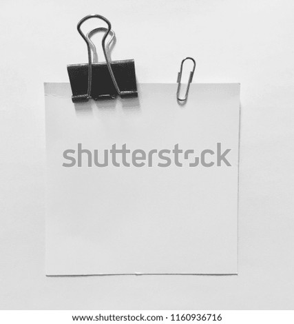 paper clip holding a blank paper sheet