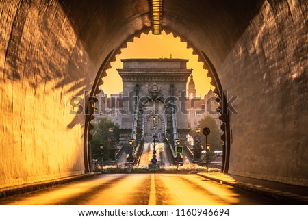 Budapest, Hungary - Entrance of the Buda Castle Tunnel at sunrise with Szechenyi Chain Bridge and Academy of Science  building at background Royalty-Free Stock Photo #1160946694