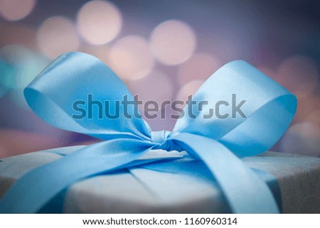 Christmas gift box with bokeh background. New year and xmas Holiday greeting card.