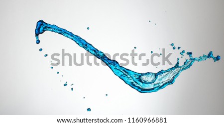 Clear, transparent blue water splash on gray background