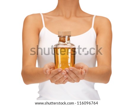 bright picture of female hands with oil bottle