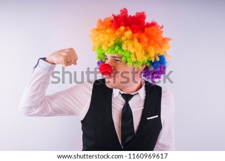 Office worker in clown wig, clown concept at work. Businessman with clown wig isolated on white
