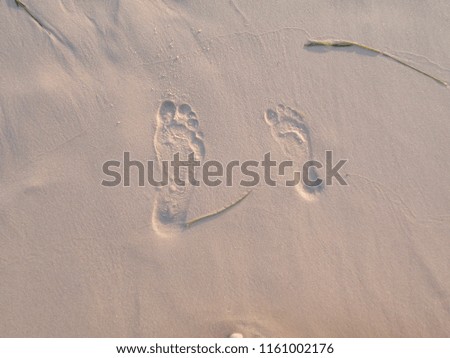 two footprints on a sand beach in Tunesia
