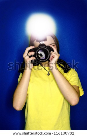 Girl photographer taking photo with digital camera and flash