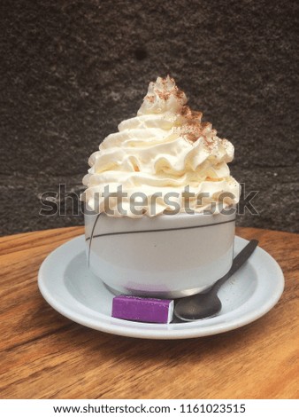 hot drink on a table with a lot of whipped cream