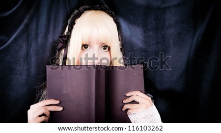Beautiful young voctorian girl reading a book