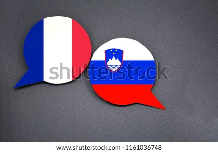 France and Slovenia flags with two speech bubbles on dark gray background