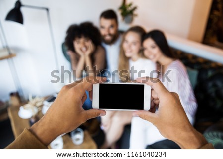 International group of friends taking photo together at modern home interior indoors