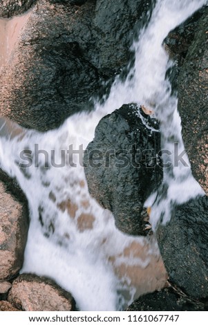 
The stream flows through the stone