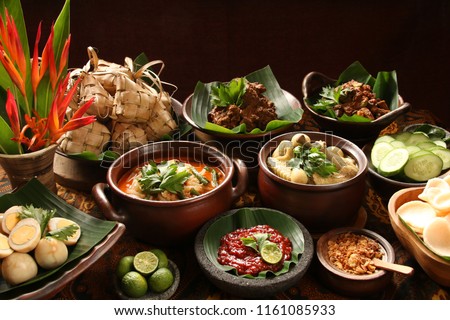 Ketupat Lebaran. Traditional celebratory dish of rice cake with several side dishes, popularly served during Eid celebrations. Royalty-Free Stock Photo #1161085933