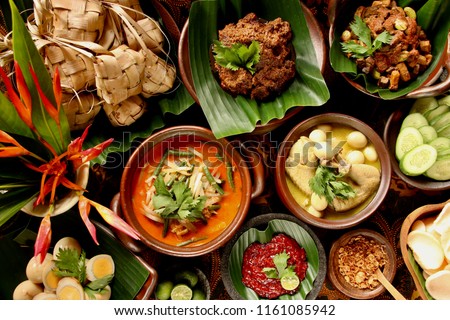 Ketupat Lebaran. Traditional celebratory dish of rice cake with several side dishes, popularly served during Eid celebrations. Royalty-Free Stock Photo #1161085942