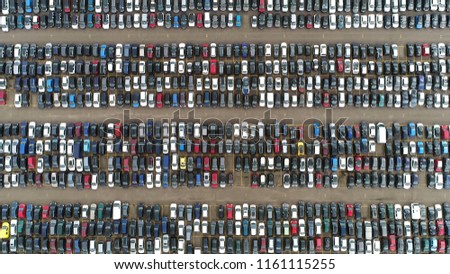 Aerial top down photo of automaker car lot showing vehicles parked close to each other ready for further distribution Royalty-Free Stock Photo #1161115255